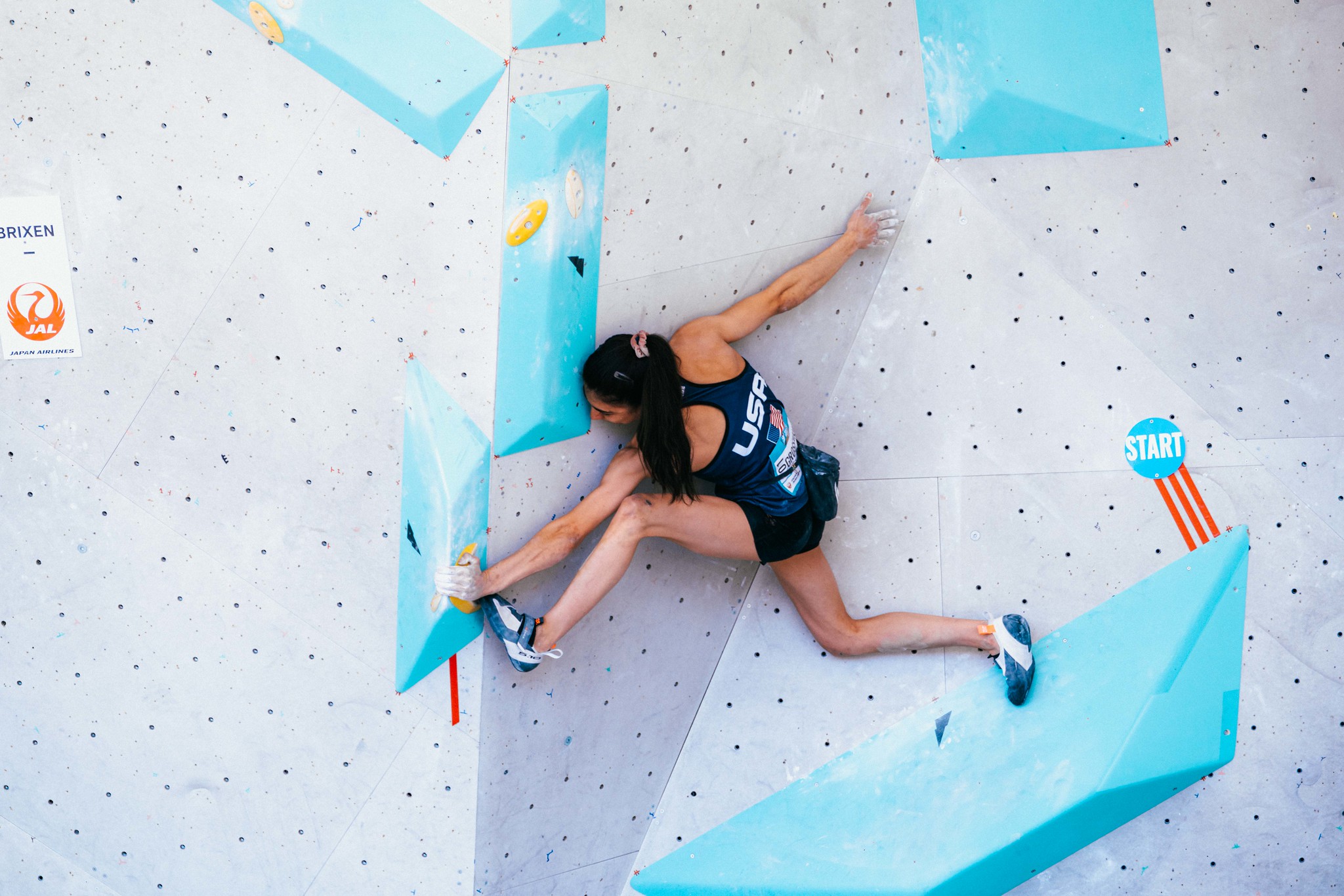 Tapes on hold to indicate how many limbs climber have to use on specific holds for the starting position